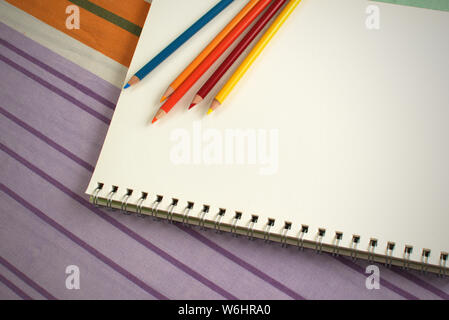 https://l450v.alamy.com/450v/w6hra0/spiral-sketch-pad-and-color-pencils-template-image-good-copy-space-back-to-school-homework-hand-drawing-artist-concept-w6hra0.jpg