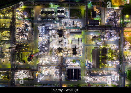 Aerial view oil refinery and gas refinery plant form industry zone at night. Stock Photo