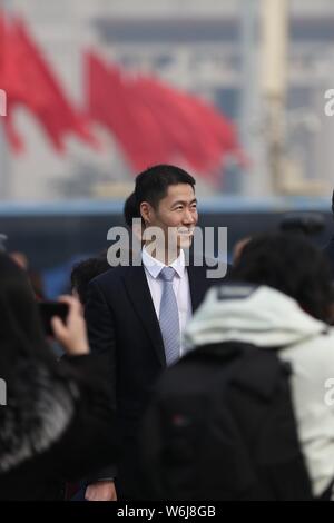 Retired Chinese table tennis player Wang Liqin arrives at the Great Hall of the People to attend the opening session for the First Session of the 13th Stock Photo