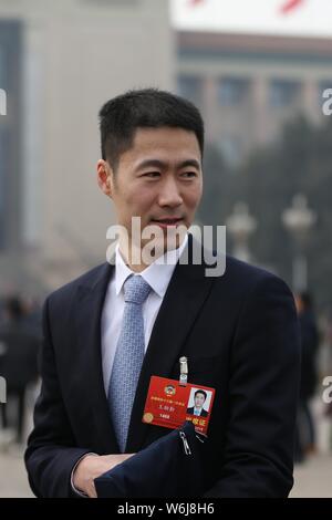 Retired Chinese table tennis player Wang Liqin arrives at the Great Hall of the People to attend the opening session for the First Session of the 13th Stock Photo