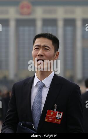 Retired Chinese table tennis player Wang Liqin arrives at the Great Hall of the People to attend the opening session for the First Session of the 13th Stock Photo