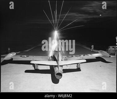 Leaving a fiery trail, .50 caliber bullets streak through the night as maintenance men of the 49th Fighter Bomber Wing in Korea, test fire a Republic F-84 Thunderjet. Wing guns will be checked and put in perfect firing order before the plane takes off in the morning on a bombing and strafing mission over enemy lines. Stock Photo
