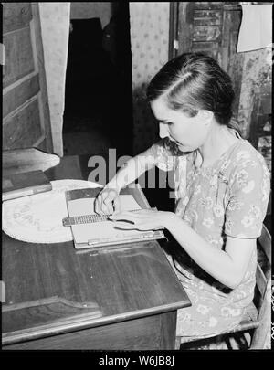 Lucy Sergent, 26, who has been blind since birth, writing. She attended the Kentucky State School for the Blind for eleven years, graduating from high school there. P V & K Coal Company, Clover Gap Mine, Lejunior, Harlan County, Kentucky. Stock Photo