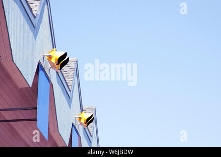 Blue sky and copy space with the peaked roof of a toll booth Stock Photo