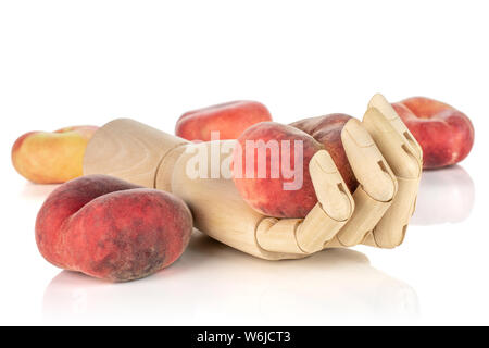 Group of four whole fresh red peach prunus persica platycarpa in wooden hand isolated on white background Stock Photo