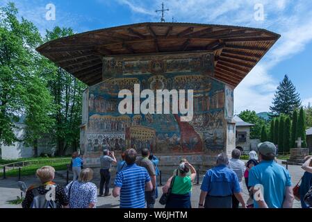 Tourists in front of wall frescoes, Last Judgement, Monastery Church Saint George, 1547, Unesco World Heritage Site, Voronet, Romania Stock Photo