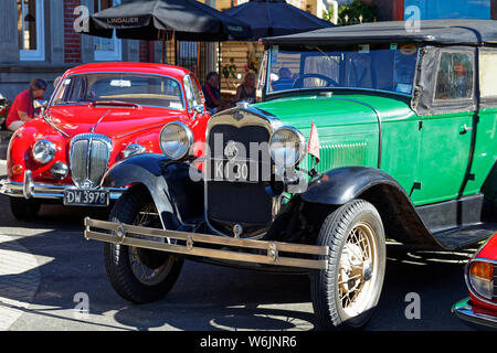Motueka, Tasman/New Zealand - February 17, 2013: Vintage car show in Motueka High Street - close up of a Jaguar and a Ford. in front of the museum. Stock Photo