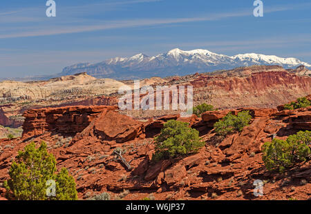 Snowy Mountains Behind a Desert Ridge in Spring in Capitol Reef National Park in Utah Stock Photo