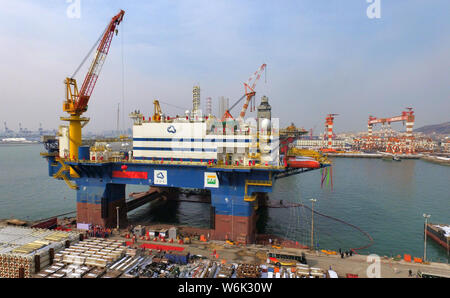 The semi-submersible accommodation vessel (SSAV), OOS Tiradentes, berths at the quay of a port before leaving for Brazil in Yantai city, east China's Stock Photo