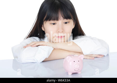 Female putting Amicana coins and placing a quarter into a piggy bank isolated on white background Stock Photo