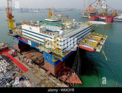 The semi-submersible accommodation vessel (SSAV), OOS Tiradentes, berths at the quay of a port before leaving for Brazil in Yantai city, east China's Stock Photo