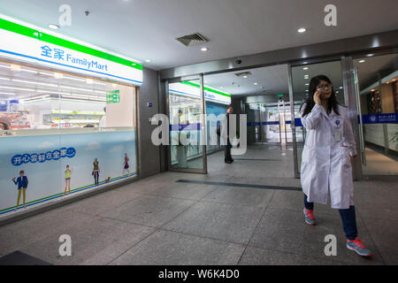 --FILE--A local resident walks past a Family Mart convenience store in Hangzhou city, east China's Zhejiang province, 8 March 2016.   JDDJ.com, an onl Stock Photo