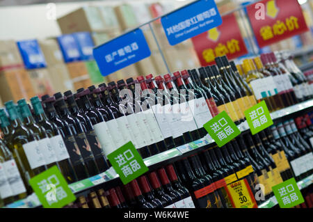 --FILE--Bottles of domestic wine and wine imported from foreign countries are for sale at a supermarket in Guangzhou city, south China's Guangdong pro Stock Photo