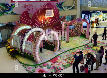 Customers take photos of the hand-crafted pop-up 3D paper artworks created by Polish artist and illustrator Bozena Rydlewska on display during the 'Ne Stock Photo