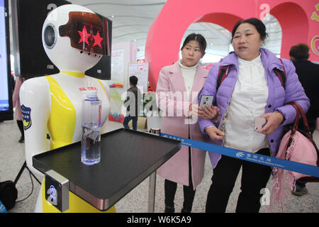 Passengers interact with automated police robots, or 