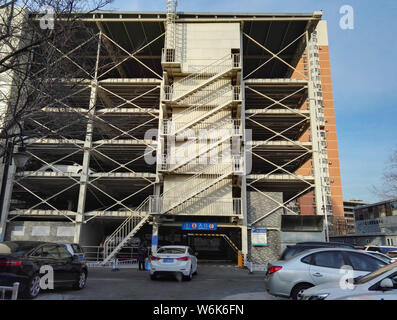 Chinese drivers queue up to park their cars in an automated stacked parking lot in the Peking University Shougang Hospital in Beijing, China, 8 Februa Stock Photo