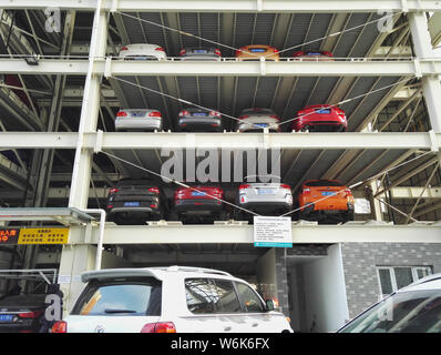 Chinese drivers queue up to park their cars in an automated stacked parking lot in the Peking University Shougang Hospital in Beijing, China, 8 Februa Stock Photo