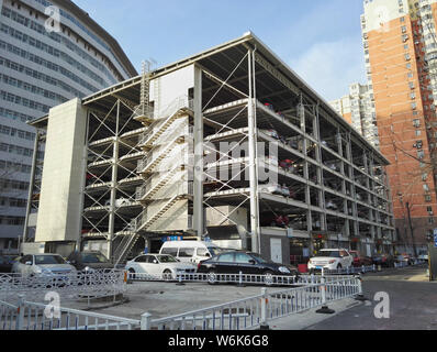 Chinese drivers queue up to park their cars in an automated stacked parking lot in the Peking University Shougang Hospital in Beijing, China, 8 Februa Stock Photo