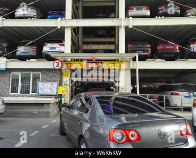 Chinese drivers queue up to park their cars in an automated stacked parking lot in the Peking University Shougang Hospital in Beijing, China, 8 Februa Stock Photo