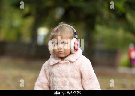 Little girl in the autumn park Stock Photo