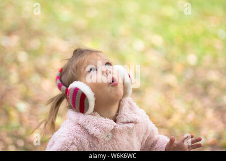 Little girl in the autumn park Stock Photo