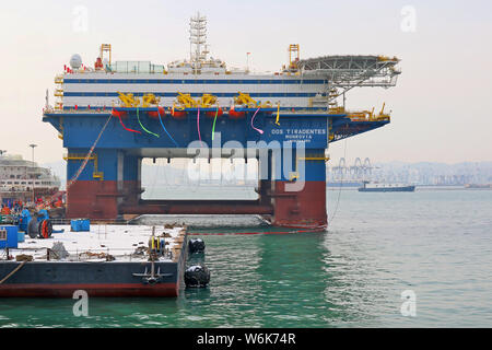 The semi-submersible accommodation vessel (SSAV), OOS Tiradentes, berths at the quay of a port before leaving for Brazil in Yantai city, east China's Stock Photo