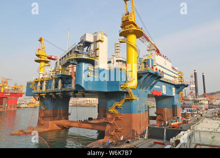 The semi-submersible accommodation vessel (SSAV), OOS Tiradentes, berths at the quay of a port before leaving for Brazil in Yantai city, east China's Stock Photo