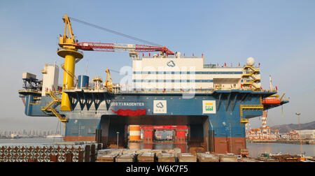 The semi-submersible accommodation vessel (SSAV), OOS Tiradentes, berths at the quay of a port before leaving for Brazil in Yantai city, east China's Stock Photo