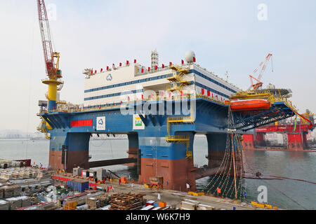 The semi-submersible accommodation vessel (SSAV), OOS Tiradentes, berths at the quay of a port before leaving for Brazil in Yantai city, east China's Stock Photo