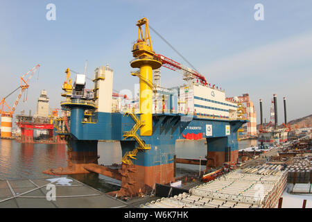 The semi-submersible accommodation vessel (SSAV), OOS Tiradentes, berths at the quay of a port before leaving for Brazil in Yantai city, east China's Stock Photo