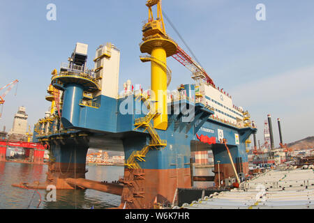 The semi-submersible accommodation vessel (SSAV), OOS Tiradentes, berths at the quay of a port before leaving for Brazil in Yantai city, east China's Stock Photo