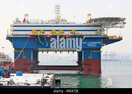 The semi-submersible accommodation vessel (SSAV), OOS Tiradentes, berths at the quay of a port before leaving for Brazil in Yantai city, east China's Stock Photo