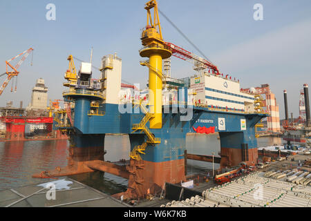 The semi-submersible accommodation vessel (SSAV), OOS Tiradentes, berths at the quay of a port before leaving for Brazil in Yantai city, east China's Stock Photo