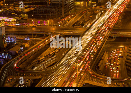 --FILE--Night view of masses of vehicles moving on an elevated highway in the CBD (Central Business District) in Beijing, China, 18 November 2015.   B Stock Photo