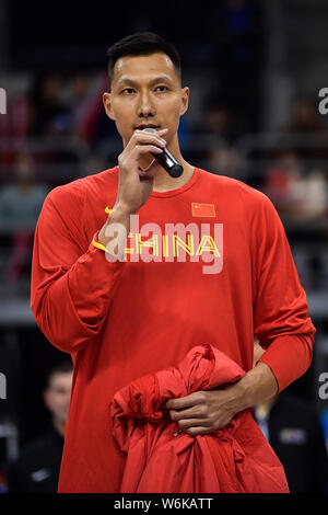 Chinese basketball player Yi Jianlian speaks as he receives a Chinese National team's jacket from retired Chinese basketball star Yao Ming, chairman o Stock Photo