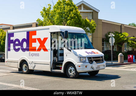 July 26, 2019 Palo Alto / CA / USA - FedEx vehicle making deliveries in San Francisco bay area Stock Photo