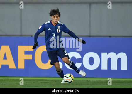 Itsuki Urata of Japan dribbles against Palestine in their Group B