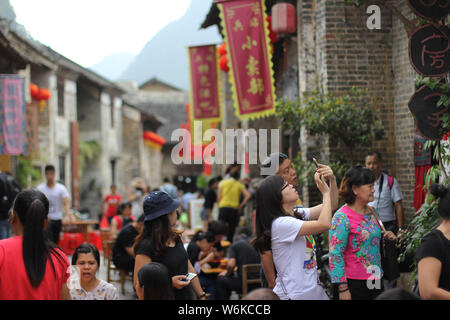--FILE--Tourists visit the Huangyao ancient town during the National Day and Mid-Autumn Festival holiday in Hezhou city, south China's Guangxi Zhuang Stock Photo