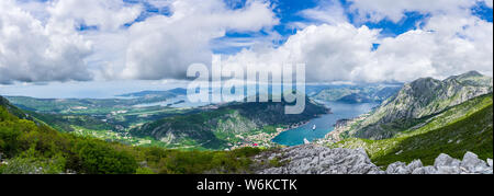 Montenegro, XXL panorama of azure waters of fjord in kotor bay with two cruise ships anchoring in harbor in spectacular nature landscape Stock Photo