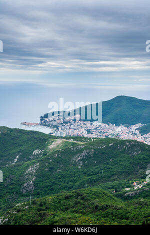 Montenegro, City budva at the coast of the ocean from above behind wide green hills and mountains nature landscape Stock Photo