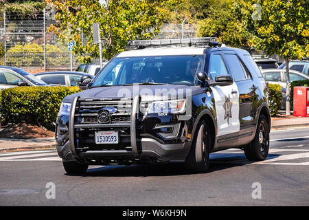 July 26, 2019 Palo Alto / CA / USA - Police car driving on the street, close to downtown Palo Alto, San Francisco bay area Stock Photo