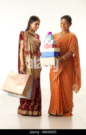 Mother with daughter with shopping bags and gifts Stock Photo