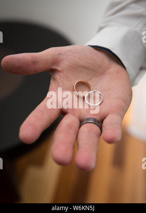 Best man holding wedding rings Stock Photo