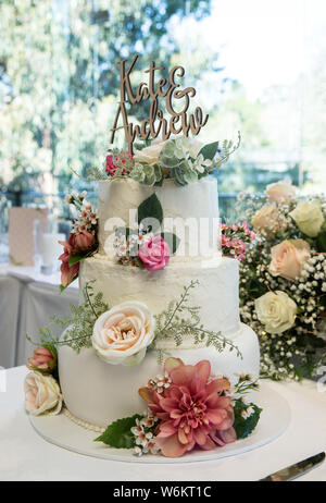 Modern wedding cake decorated with flowers Stock Photo
