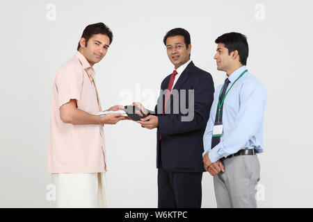 Executive handing keys to buyer Stock Photo
