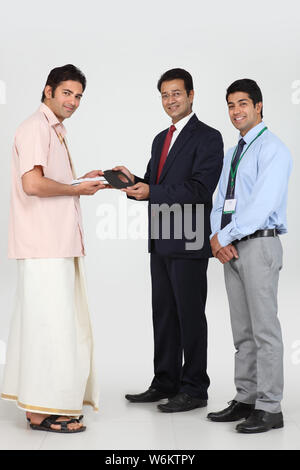 Executive handing keys to buyer Stock Photo