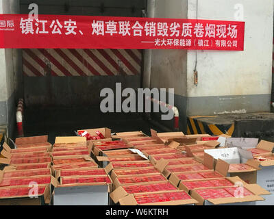 2,333 cartons of counterfeit Zhonghua brand cigarettes to be destroyed are placed next to an incinerator during a winter operation in Zhenjiang city, Stock Photo