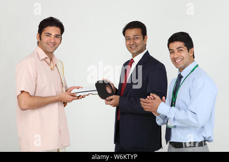 Executive handing keys to buyer Stock Photo