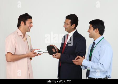 Executive handing keys to buyer Stock Photo