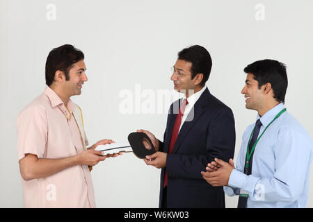 Executive handing keys to buyer Stock Photo